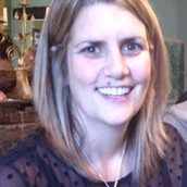 A head shot of a woman who is looking at the camera and smiling.